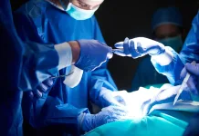Surgeons passing scissors to each other